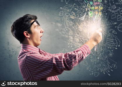 Guy using tablet pc. Young man looking shocked in tablet pc