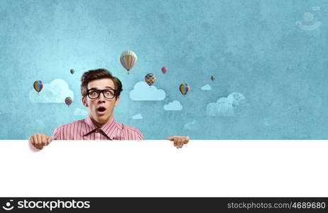 Guy with banner. Young man in casual holding white blank banner