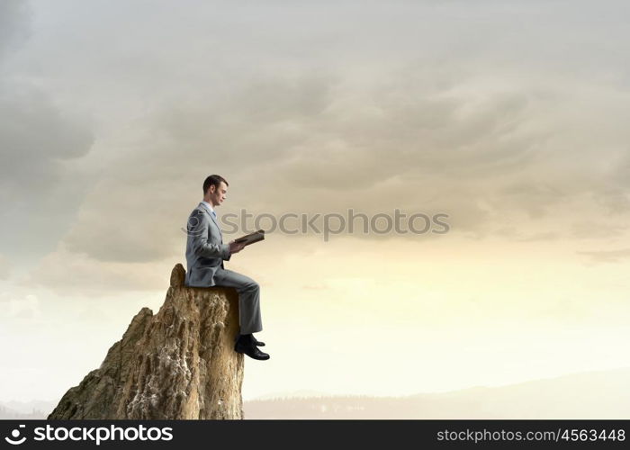 Guy with book. Young handsome businessman with old book in hands