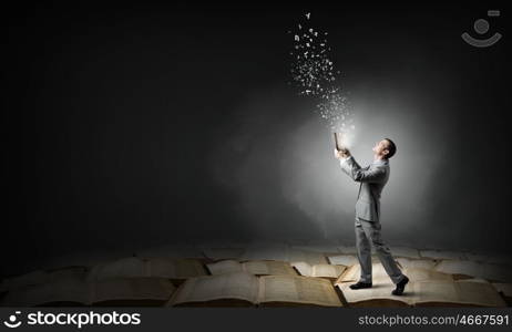 Guy with book. Young handsome businessman with old book in hands