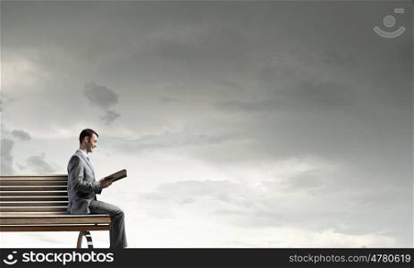 Guy with book. Young handsome businessman with old book in hands
