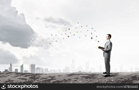 Guy with book. Young handsome businessman with old book in hands