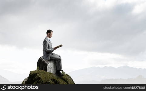 Guy with book. Young handsome businessman with old book in hands
