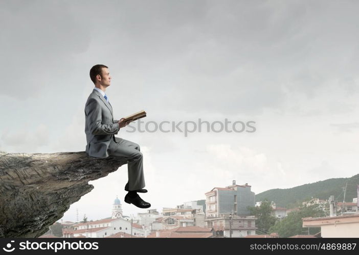 Guy with book. Young handsome businessman with old book in hands