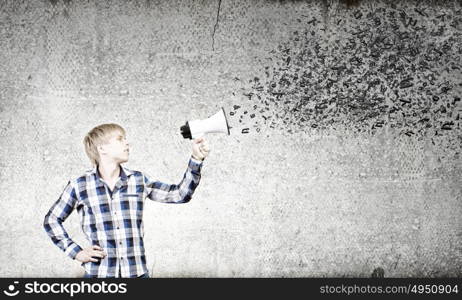 Guy with megaphone. Young man in casual announcing something in megaphone