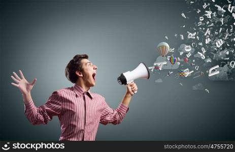 Guy with megaphone. Young man in casual screaming in megaphone