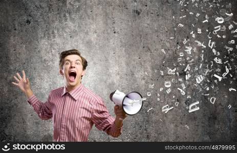 Guy with megaphone. Young man in casual screaming in megaphone