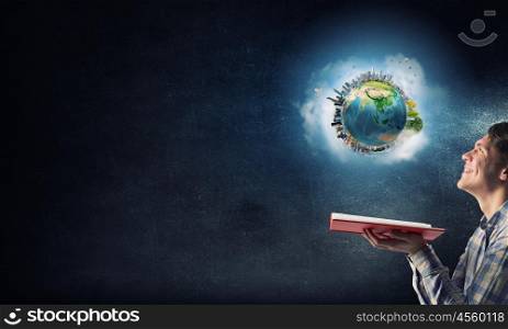 Guy with red book in hand. Young man with opened book in hands. Elements of this image are furnished by NASA