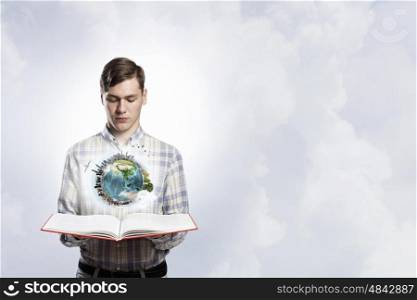 Guy with red book in hand. Young man with opened book in hands. Elements of this image are furnished by NASA