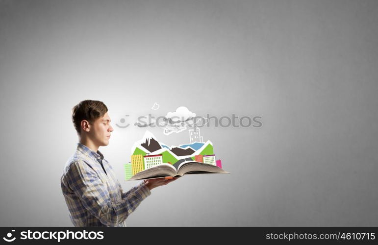 Guy with red book in hands. Young man in casual holding opened book with construction concept