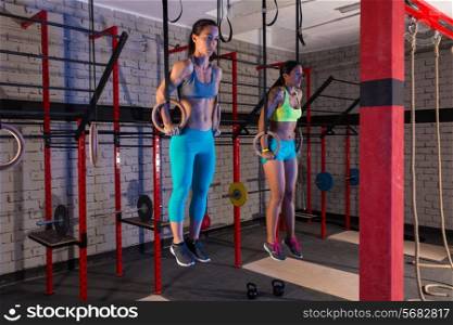 Gym girls muscle ups rings workout at gym