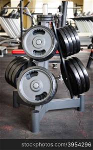 Gym interior with barbell plates holder rack