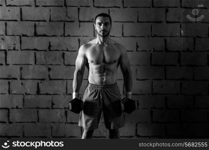 gym man holding hex dumbbells with muscle torso