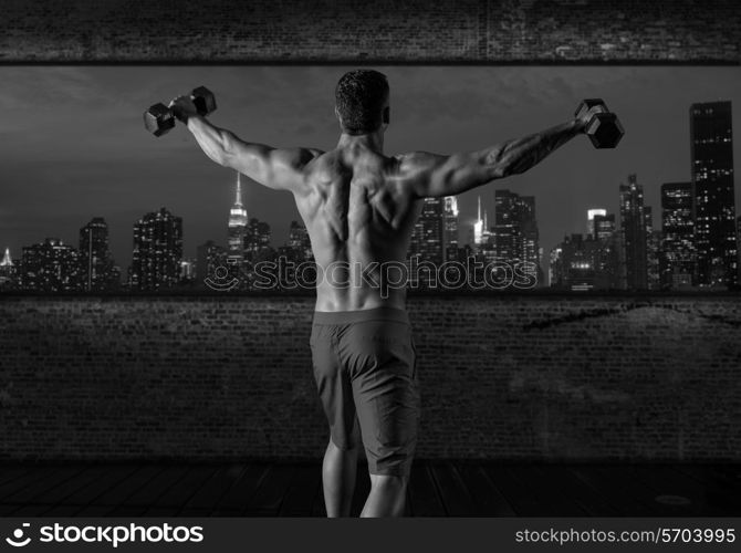 gym man rising hex dumbbells in New York city skyline at night rear view photo mount