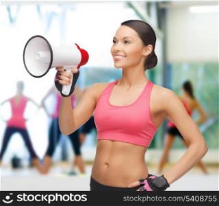 gym, sport and training concept - beautiful sporty woman with megaphone