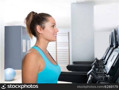 Gym treadmill women indoor exercise blue eyes girl smiling