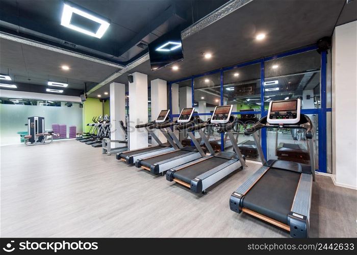 gym with exercise equipment and a black ceiling. gym with a black ceiling
