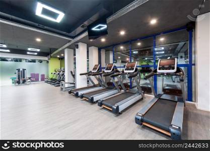 gym with exercise equipment and a black ceiling. gym with a black ceiling