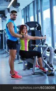 Gym woman exercising with her personal trainer