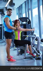 Gym woman exercising with her personal trainer