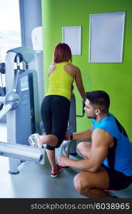 Gym woman exercising with her personal trainer