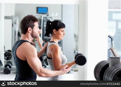 gym woman personal trainer man with weight training equipment
