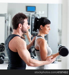 gym woman personal trainer man with weight training equipment