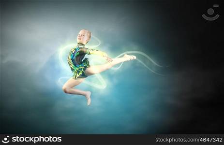 Gymnast girl. Little cute girl gymnast making high jump