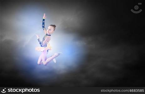 Gymnast girl. Little cute girl gymnast making high jump