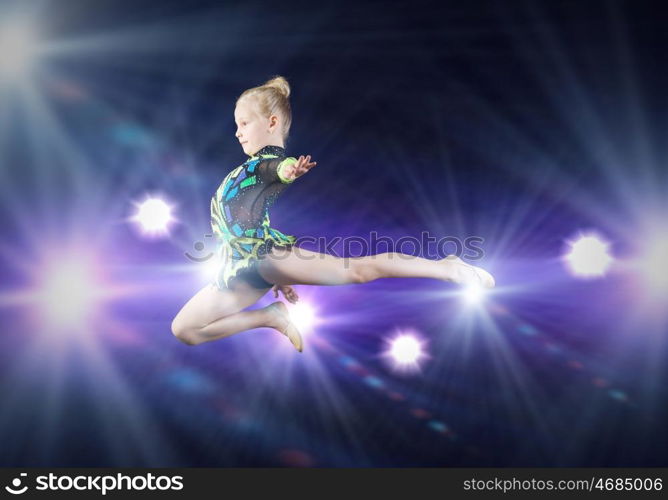 Gymnast girl. Little cute girl gymnast making high jump