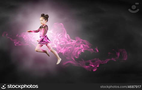 Gymnast girl. Little cute girl gymnast making high jump