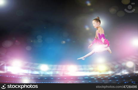 Gymnast girl. Little cute girl gymnast making high jump