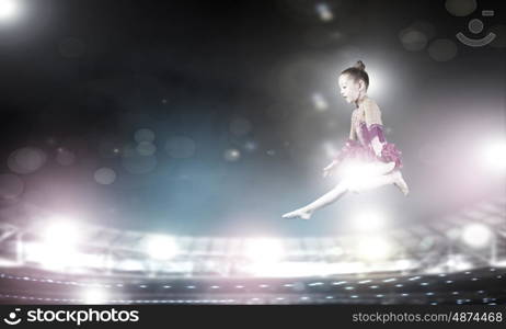 Gymnast girl. Little cute girl gymnast making high jump