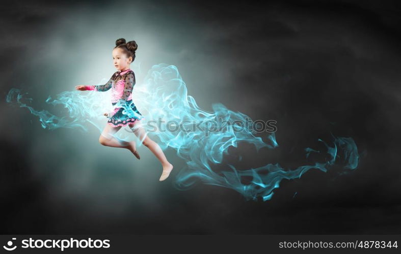 Gymnast girl. Little cute girl gymnast making high jump