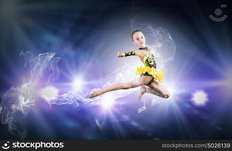 Gymnast girl. Little cute girl gymnast making high jump