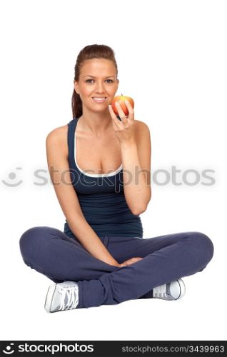 Gymnastics girl with an apple sitting with cross-legs on white background