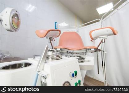 Gynecological cabinet with chair and other medical equipment in modern clinic. Gynecological cabinet in modern clinic
