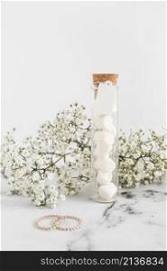 gypsophila flowers wedding rings marshmallow test tube white background