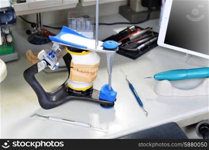 gypsum model of jaw and basic dentist tools
