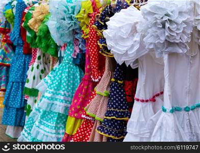 gypsy dresses hanging in a row in an andalusian Spain outdoor market