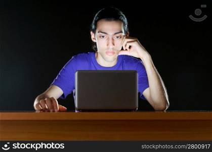 Hacker sitting in dark room