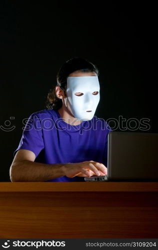 Hacker sitting in dark room