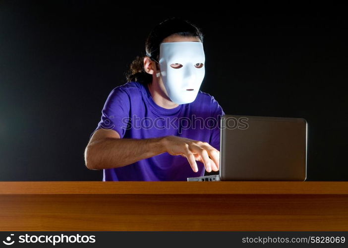 Hacker sitting in dark room