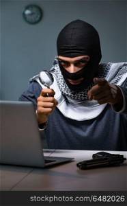 Hacker wearing balaclava mask hacking computer