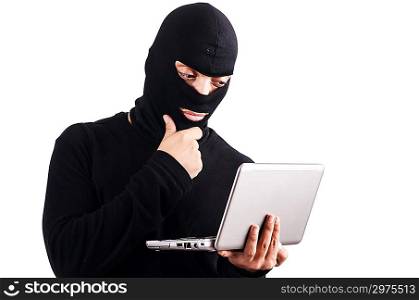 Hacker with computer wearing balaclava