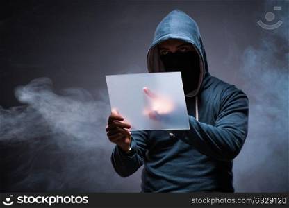 Hacker working on tablet in dark