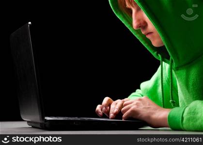 hacker. Young man with laptop is looking at screen