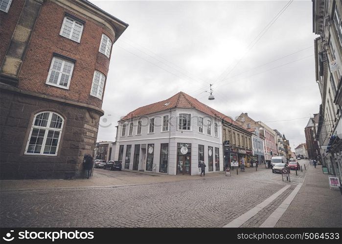 HADERSLEV, DENMARK - MARCH 25 - 2017: Cars driving down a shopping street in Haderslev city in Denmark
