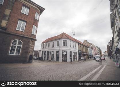 HADERSLEV, DENMARK - MARCH 25 - 2017: Cars driving down a shopping street in Haderslev city in Denmark