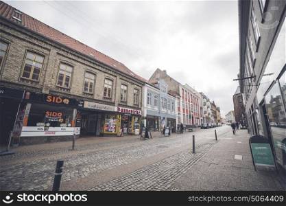 HADERSLEV, DENMARK - MARCH 25 - 2017: Shopping street in Haderslev city in Denmark with old buildings and stores